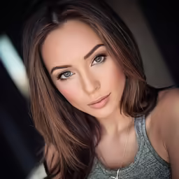 a pretty young woman posing for the camera