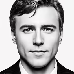 a man in a suit and tie looking at the camera