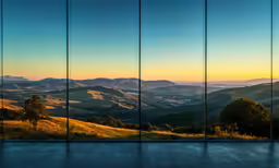 a wide shot of mountains and fields is seen from the outside