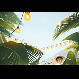 a woman wearing a white hat standing under the palm trees with lights strung from the ceiling