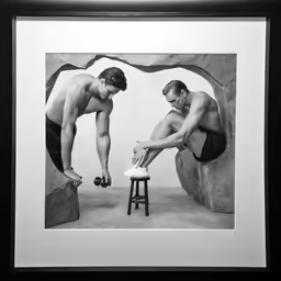 a couple of guys in bathing suits touching each other