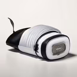 a white and black cat shaped object is sitting