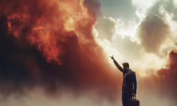 a man in a suit points toward a red cloud