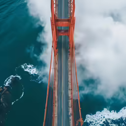 a photo of the golden gate bridge in the clouds