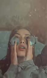 the woman is holding two pairs of binoculars