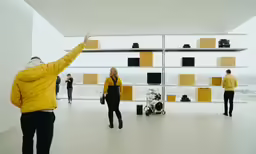 an older man is pointing at his exhibit