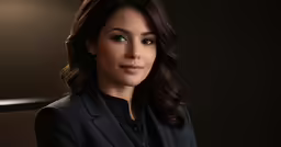 a beautiful woman in a black suit posing for the camera