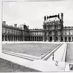 old black and white photo of large building with circular dome