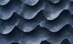 an overhead view of the ocean with waves and rocks in the water