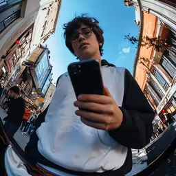 a man looking up at the sky while holding a cell phone