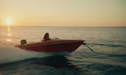 a woman and man in the ocean riding a boat
