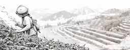 man with large backpack looking down a mountain