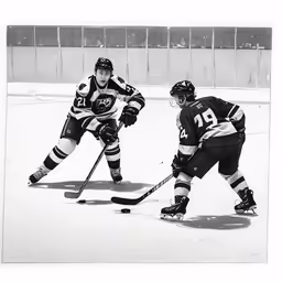 two men on the ice playing in a hockey game