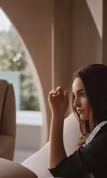 a woman sitting on a couch looking ahead