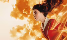 a young woman in a red dress flying through the air
