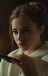 a woman is holding something in her hand