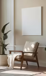 an empty canvas hangs above the chair with a blanket on it