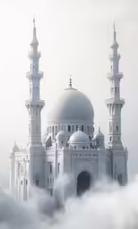 the two very large towers of the building are perched above the clouds