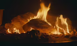 fire burns in the middle of a rocky area