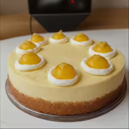 a cheese cake with eggs on top on a white table