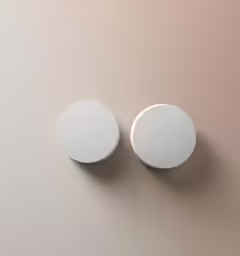 two white round knobs on a brown surface