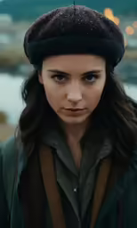 a woman with brown and black hair wearing a hat