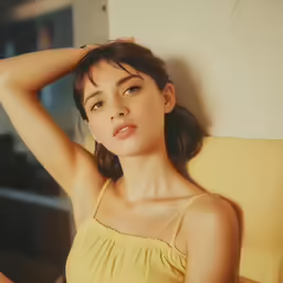 a woman wearing a yellow dress with a tan strap