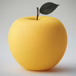 a yellow apple on a white surface with a green leaf on top