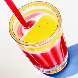 a colorful drink that is on top of a table