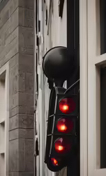 a red traffic light sitting on the side of a building