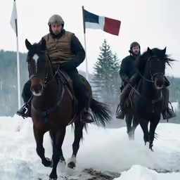 two men on horses galloping through the snow
