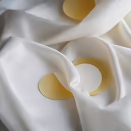 a cloth has several circles of round and circular buttons on it