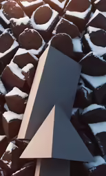 a large pile of chocolate brownies with a metal triangle on the top