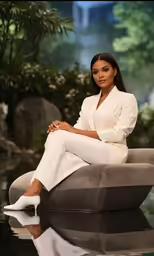 a woman sitting on top of a grey chair