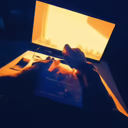 an open laptop computer on a black table
