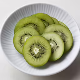 four slices of kiwi in a white bowl