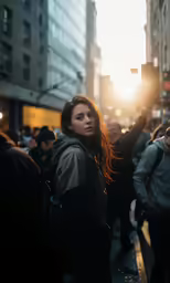 a woman with a backpack stands in the street