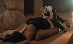 a woman laying on the ground next to a man