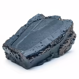 a piece of black substance sitting on top of a piece of cake