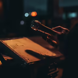 an unreasonned person holding a wine glass looking at it