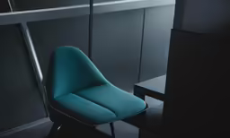 blue chair at table near gray wall, dark room