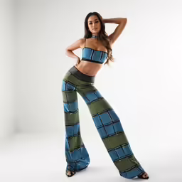 the woman poses in her pant and top