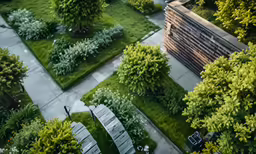 an aerial view of a garden with benches and trees