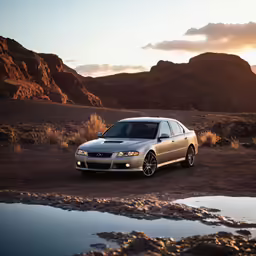 an silver car parked on a dirt road