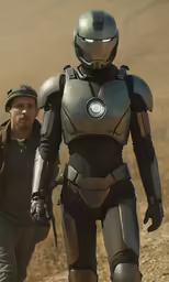 a man walks in a futuristic suit while holding a baseball bat