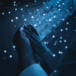 two people holding hands against a night sky background