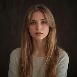 young girl wearing white shirt and long blonde hair