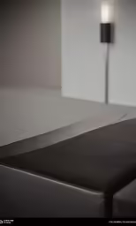 the side of a bench with a black seat