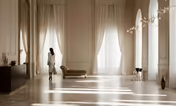 the woman is standing in the room looking at the floor