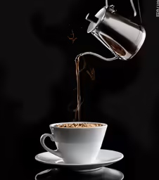 a coffee cup pouring from a kettle